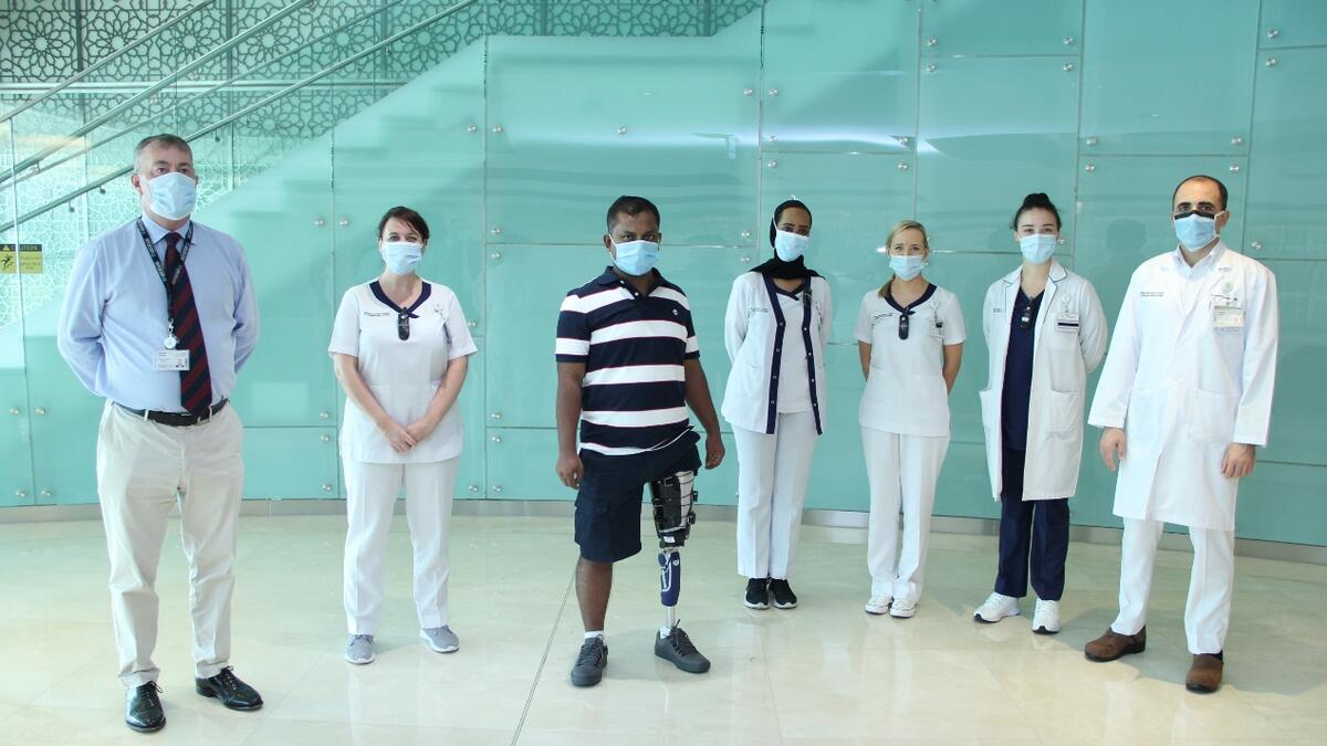 UAE worker, grocery employee, leg, infection, back on feet, social workers, 
