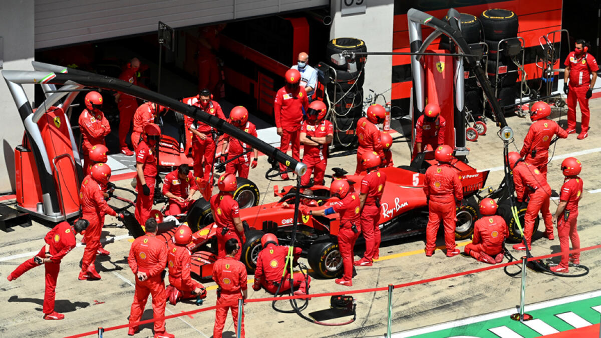 Ferrari's engineers with Sebastian Vettel's car before the race, following the resumption of F1 after the outbreak of the coronavirus disease. - Reuters
