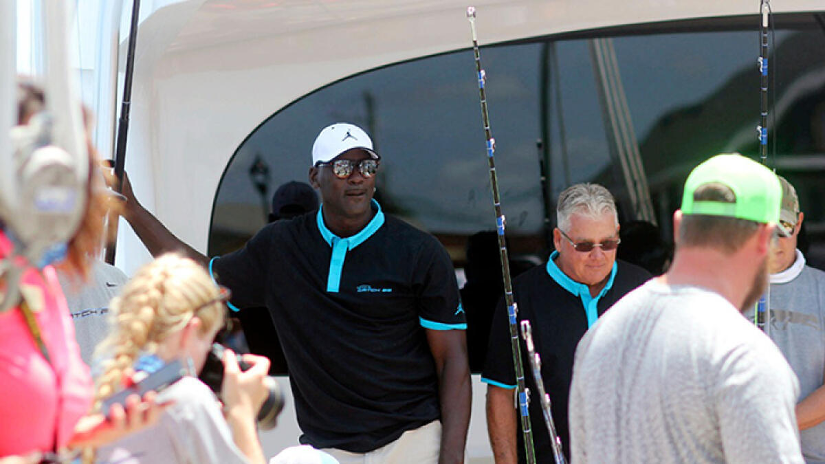 Michael Jordan stands on his boat Catch 23, which brought in a 442.3-pound marlin on Tuesday during the second day of the Big Rock Blue Marlin Tournament in Morehead City. -- AP