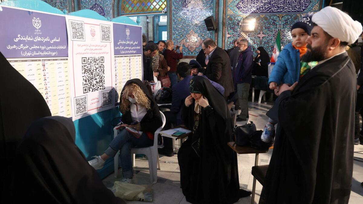 Iranians vote during the parliamentary election at a polling station in Tehran. — Reuters