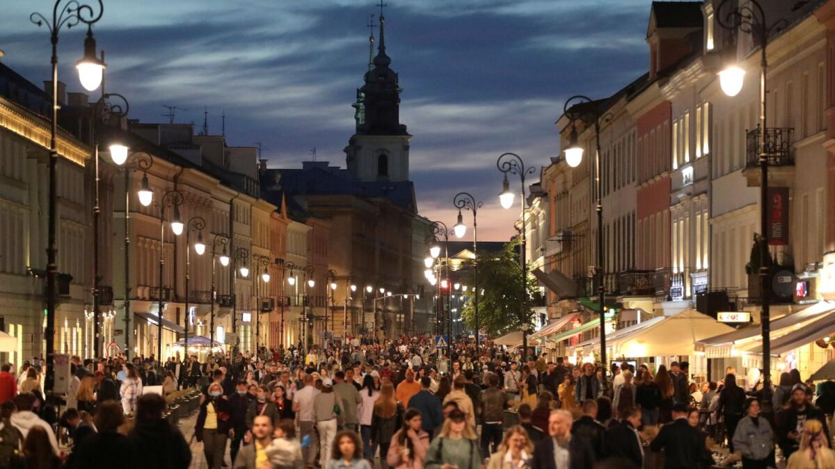 People walk in the city centre in Warsaw as the country's Covid-19 restrictions are eased.