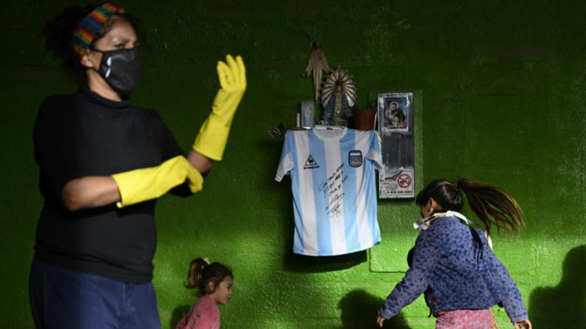Diego Maradona's autographed shirt is displayed at a community eatery in Buenos Aires. -- AFP