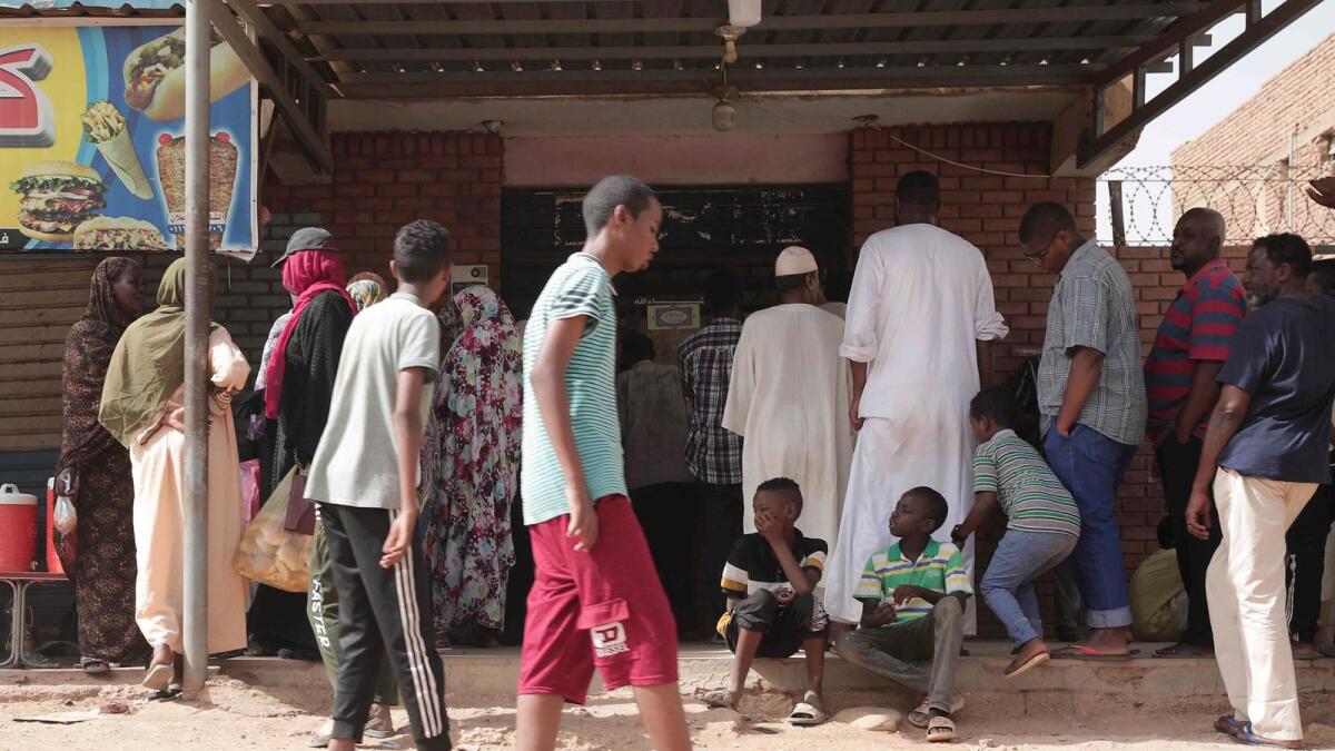People line up in front of a bakery during a ceasefire in Khartoum, Sudan, on Saturday. — AP