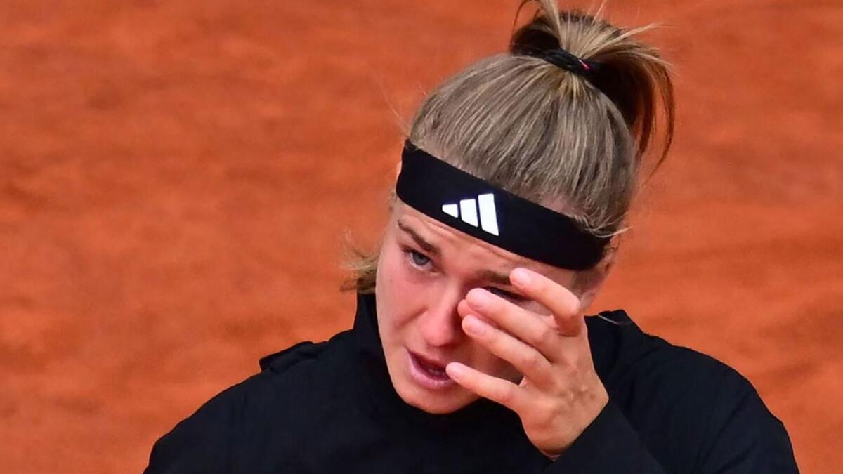 Czech Republic's Karolina Muchova wipes away her tears after being defeated by Poland's Iga Swiatek during their women's singles final. - AFP