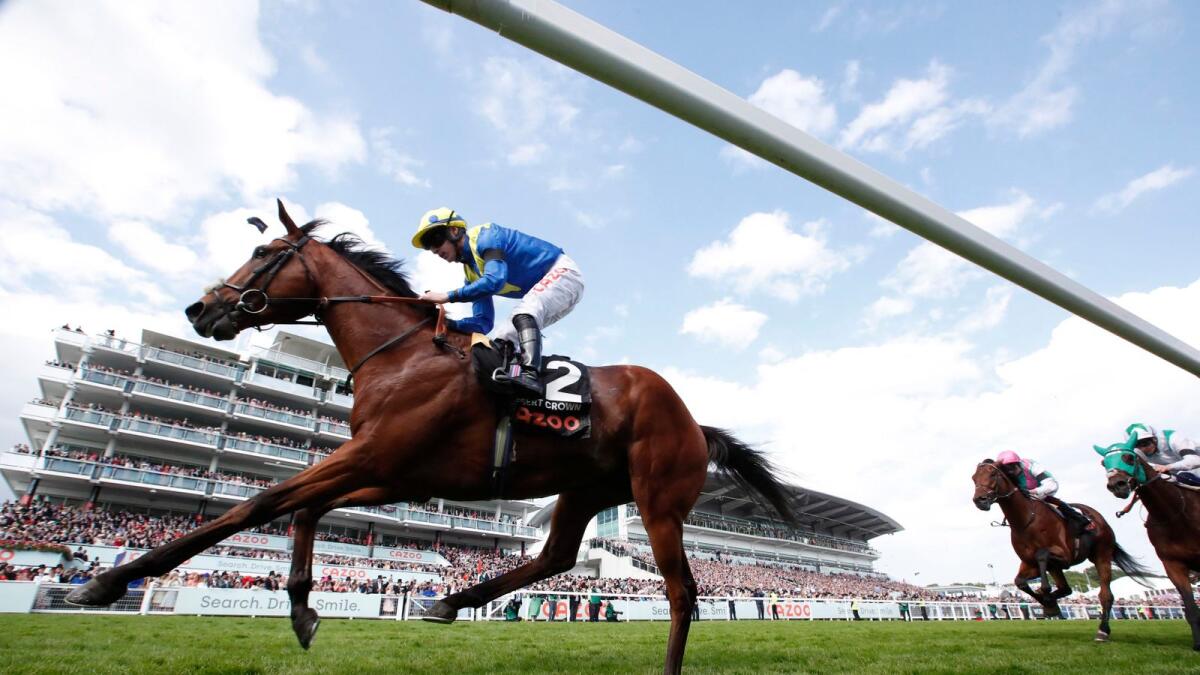 Desert Crown, ridden by Richard Kingscote, wins the Epsom Derby on Saturday. — Reuters