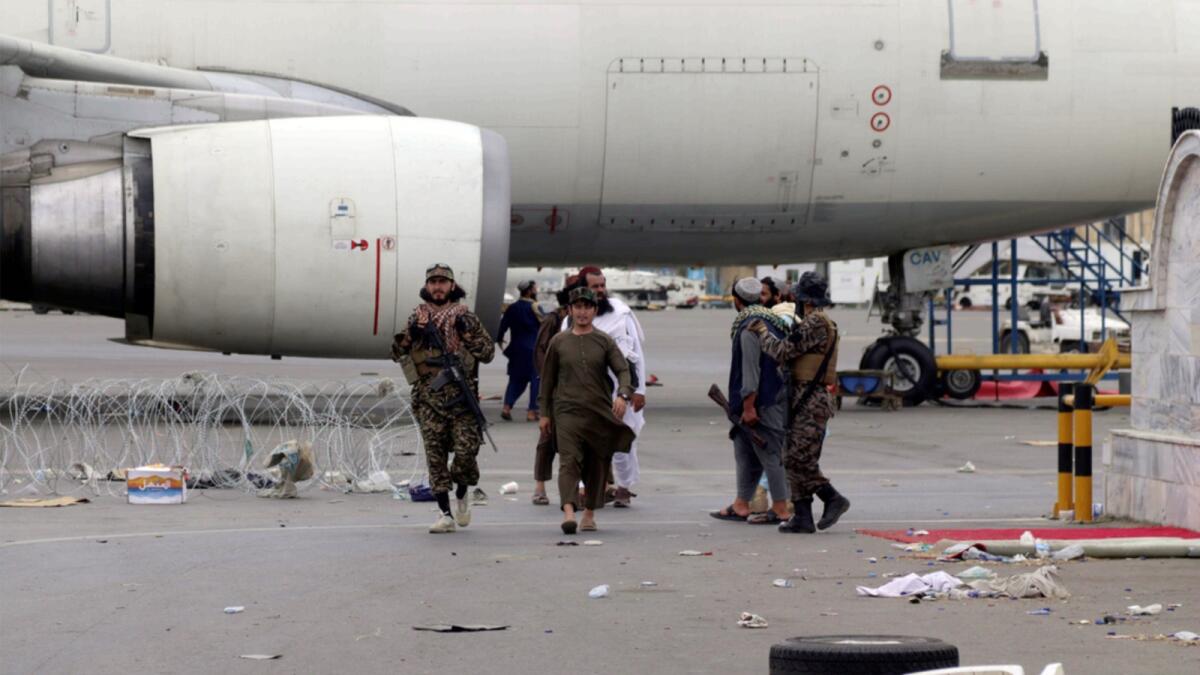 Taliban special force fighters gather inside Kabul airport after the US military's withdrawal. — AP
