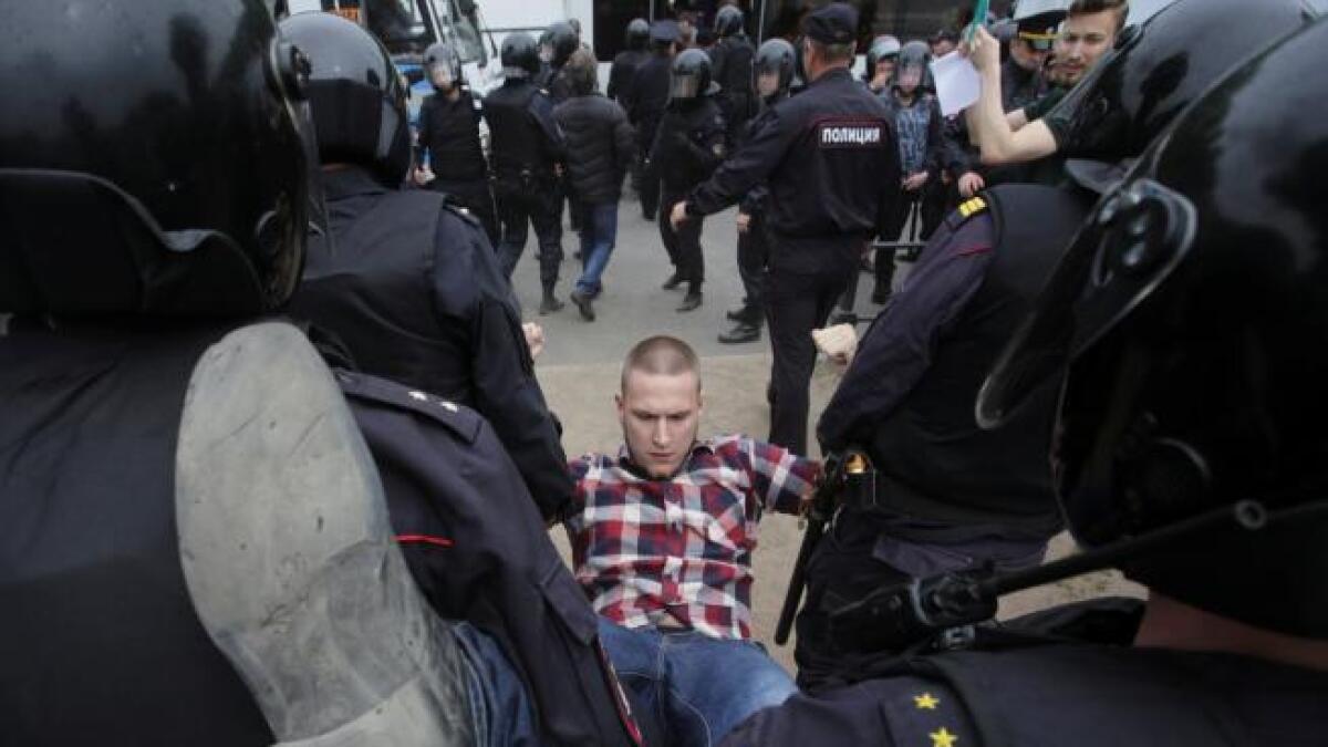 Riot police detain a demonstrator during an anti-corruption protest organised by opposition leader Alexei Navalny, on Tverskaya Street in central Moscow. (Reuters)