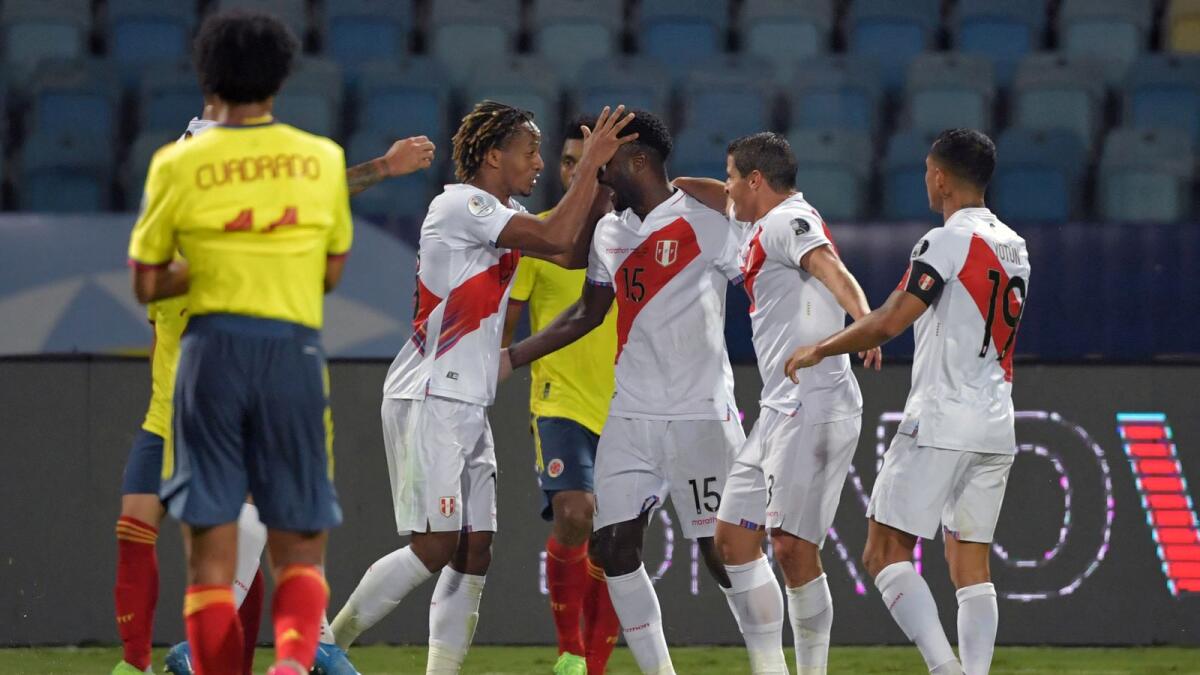 Peru's players celebrate after Colombia's Yerry Mina scored an own goal. (AFP)