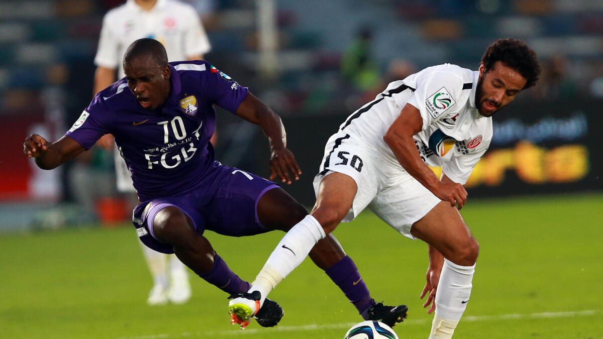 Al Ain's Danilo Asprilla is challenged by Al Jazira's Mohammed Jamal during the President's Cup final on Sunday.