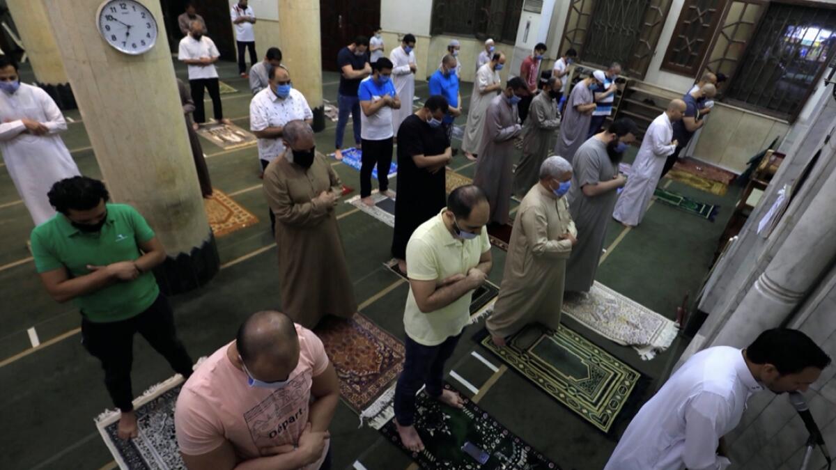 Worshippers wearing protective masks perform amid social distancing markers, first prayers of Al Fajr prayer inside the Al Rahman Mosque after months of lockdown, following the outbreak of the coronavirus disease (Covid-19), in the Cairo neighborhood Maadi, Egypt. Photo:  Reuters
