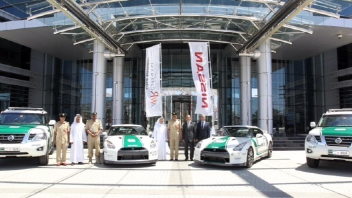 Dubai Police chief with the new additions - the Nissan Patrol and GTR