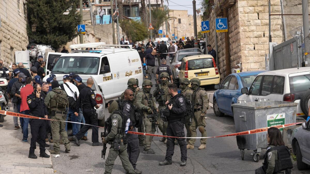 Israeli policemen secure a shooting attack site in east Jerusalem on Saturday. — AP