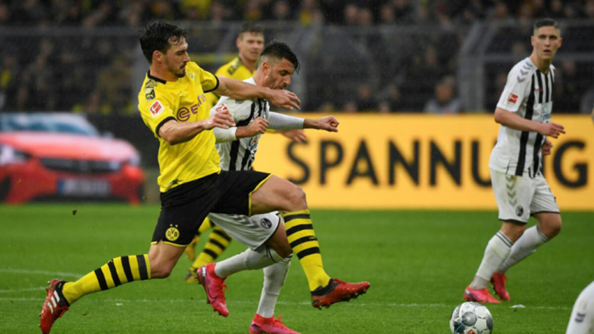Key Dortmund defender Mats Hummels (left) is '99 precent' ready to face former club Bayern Munich on Tuesday after an Achilles tendon knock. -- AFP
