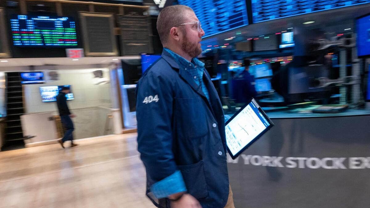 Traders work on the floor of the New York Stock Exchange (NYSE) on the first day back since the Christmas holiday on  Tuesday. — AFP
