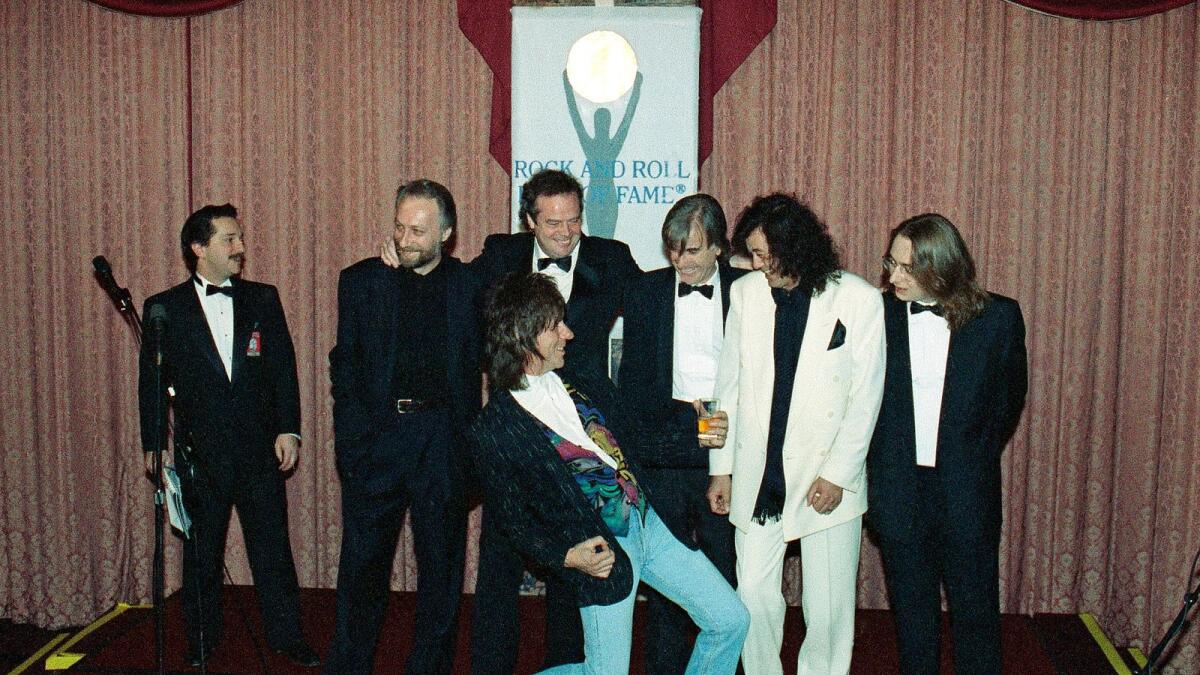 Jeff Beck plays the air guitar for Jimmy Page, second from right, as unidentified members of the Yardbirds look on at New York's Waldorf Astoria Hotel, on January 15, 1992, as the group was on hand for their induction during the Seventh Annual Rock and Roll Hall of Fame Dinner.
