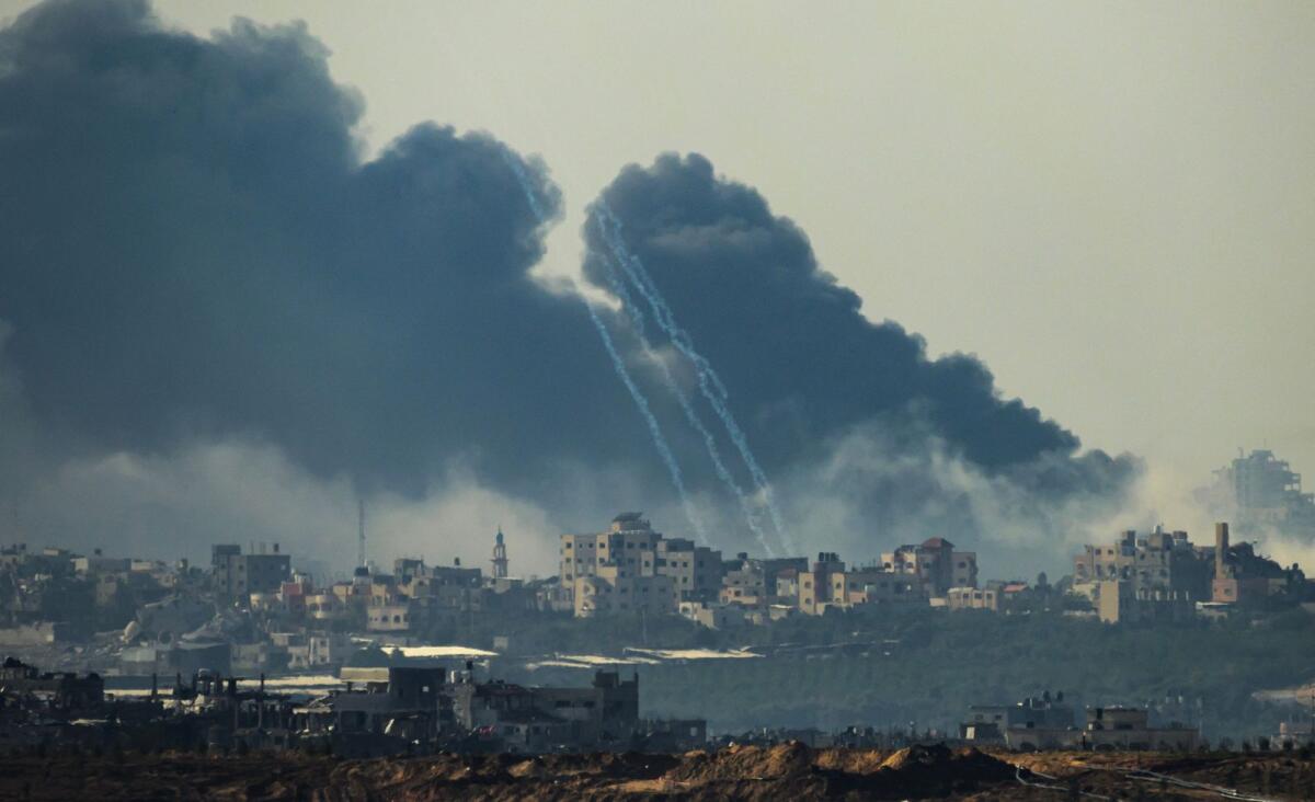 This picture taken from southern Israel near the border with the Gaza Strip shows smoke rising from buildings after being hit by Israeli strikes as the temporary ceasefire ended on December 1. — AFP