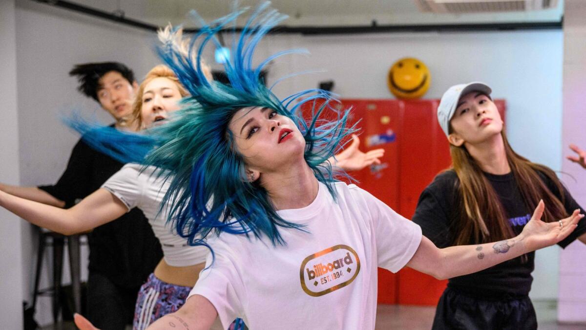 AleXa (C) takes part in a rehearsal with her dance crew in a dance studio of South Korea's ZB Label in Seoul.