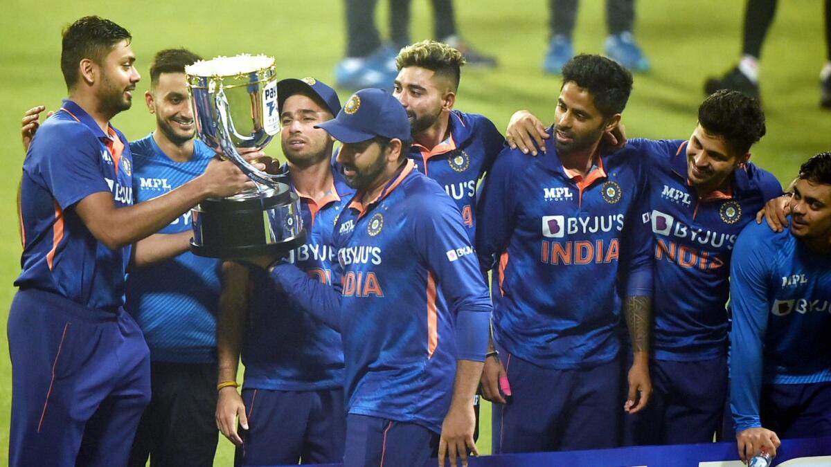 Indian skipper Rohit Sharma hands over the trophy to the youngsters after winning the third and final T20 against the West Indies, at Eden Gardens, in Kolkata, on Sunday. — PTI