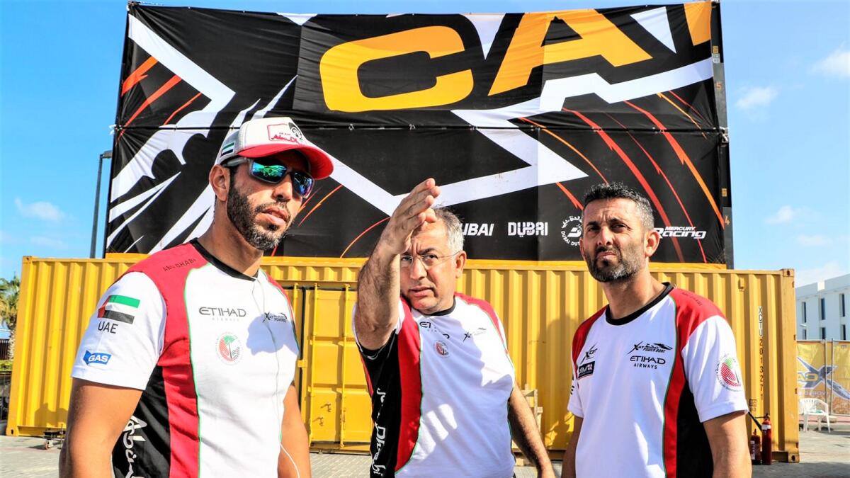 Team Abu Dhabi’s Rashed Al Tayer (left) and Shaun Torrente (right) with technical manager Talib Al Sayed