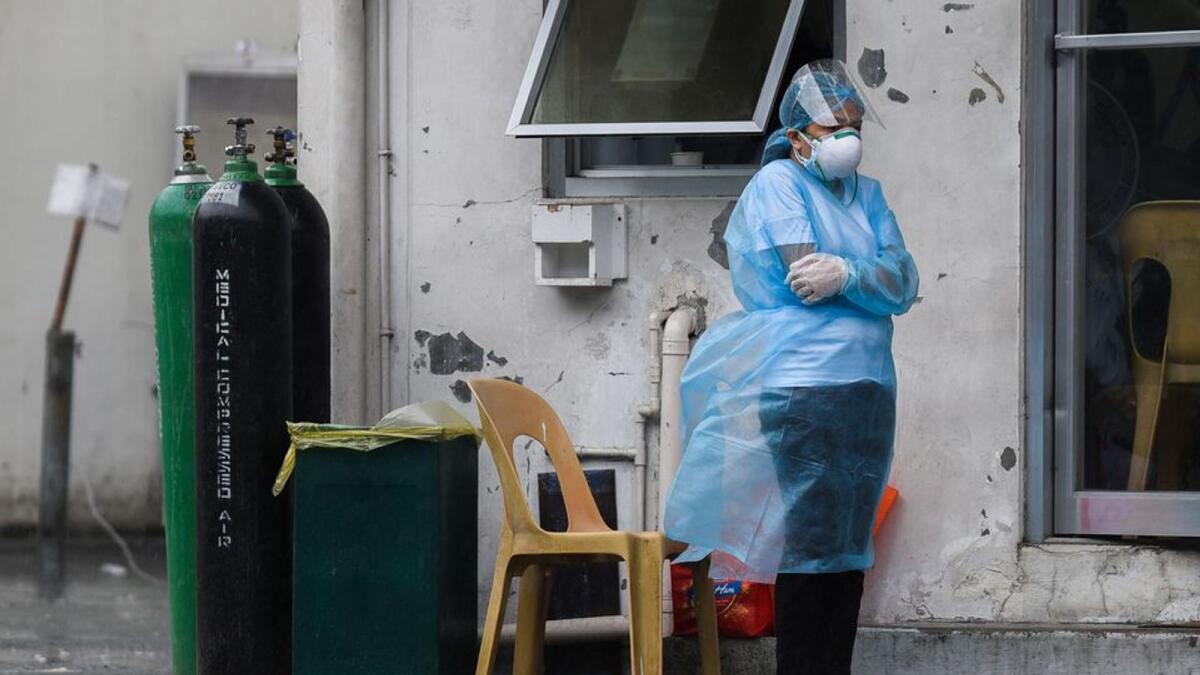 A health worker wearing personal protective equipment (PPE) as protection against the coronarivus disease (COVID-19) stands near the triage area of Sta. Ana Hospital, in Manila, Philippines, September 8, 2021 (Reuters)