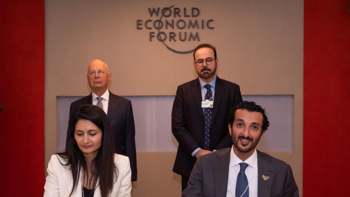 Abdulla bin Touq Al Marri, UAE Minister of Economy, and Saadia Zahidi, managing director at the World Economic Forum, signing the agreement. — Supplied photo