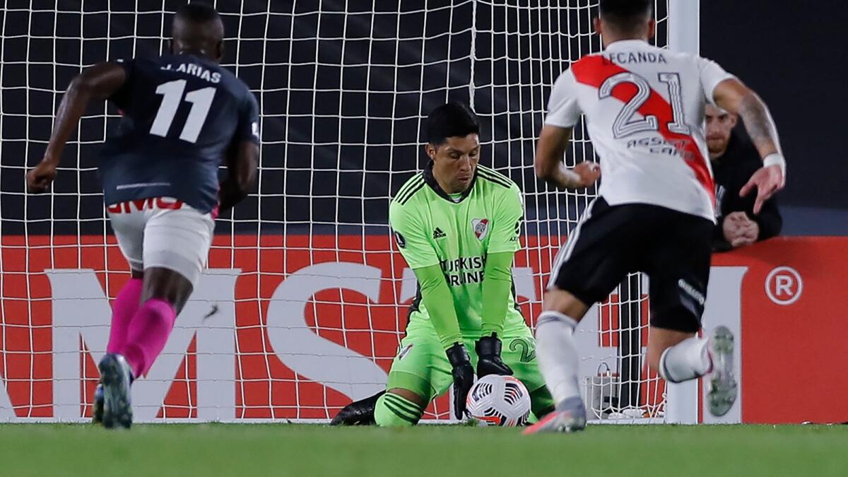 Playing as a goalkeeper, River Plate midfielder Enzo Perez makes a save during the Copa Libertadores match in Buenos Aires. (AFP)