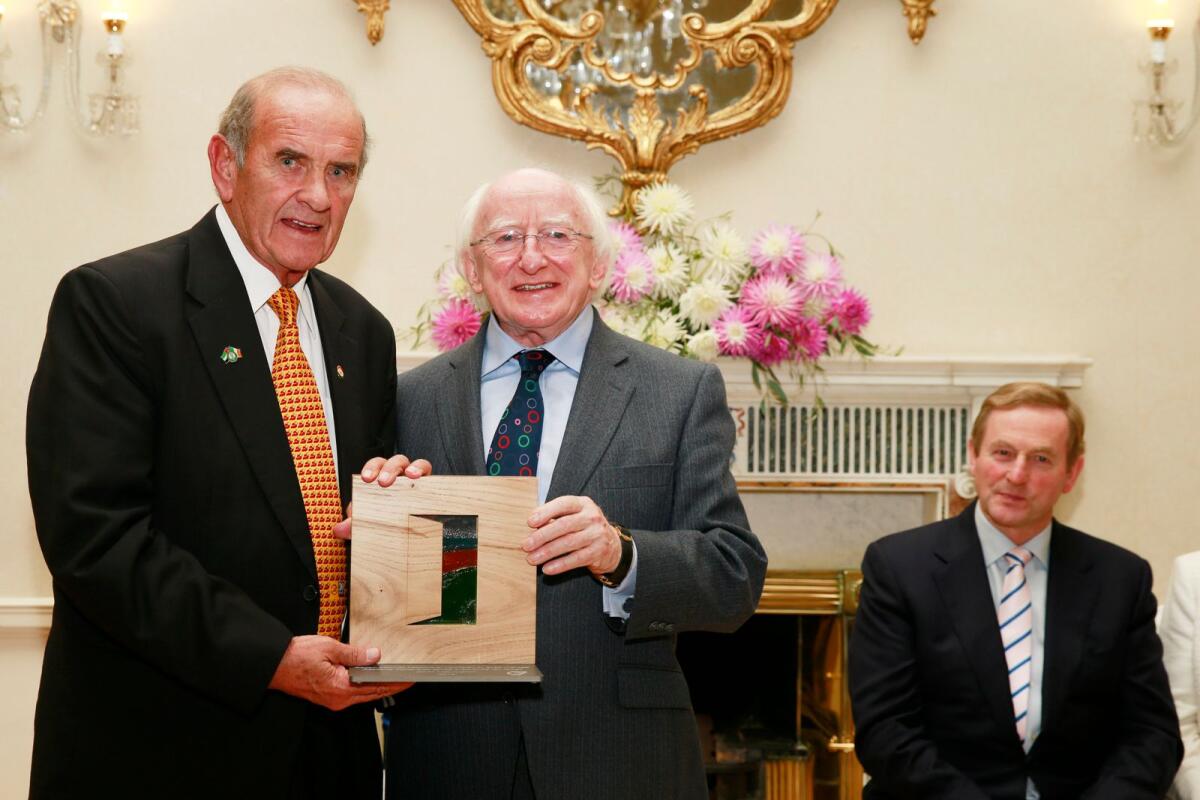 Colm McLoughlin accepts the Irish Presidential Distinguished Service Award for the Irish Abroad in Business and Education category from Ireland’s President Michael D. Higgins, at a special ceremony held in the presidential residence Áras an Uachtaráin in Dublin, while An Taoiseach Enda Kenny (right) looks on. Supplied photo