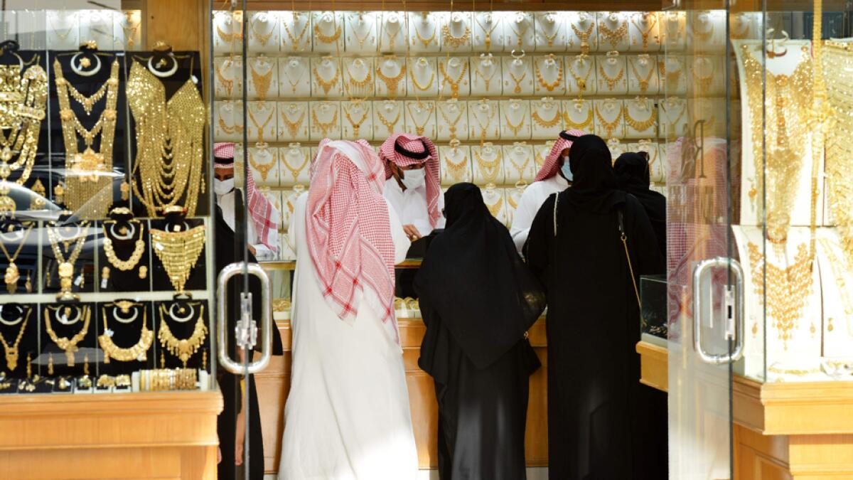 Saudis shop at a jewellery shop in the Tiba gold market in the capital Riyadh, after authorities announced a 10% increase in the VAT rate, to reach 15%, starting from first of July. Photo: AFP