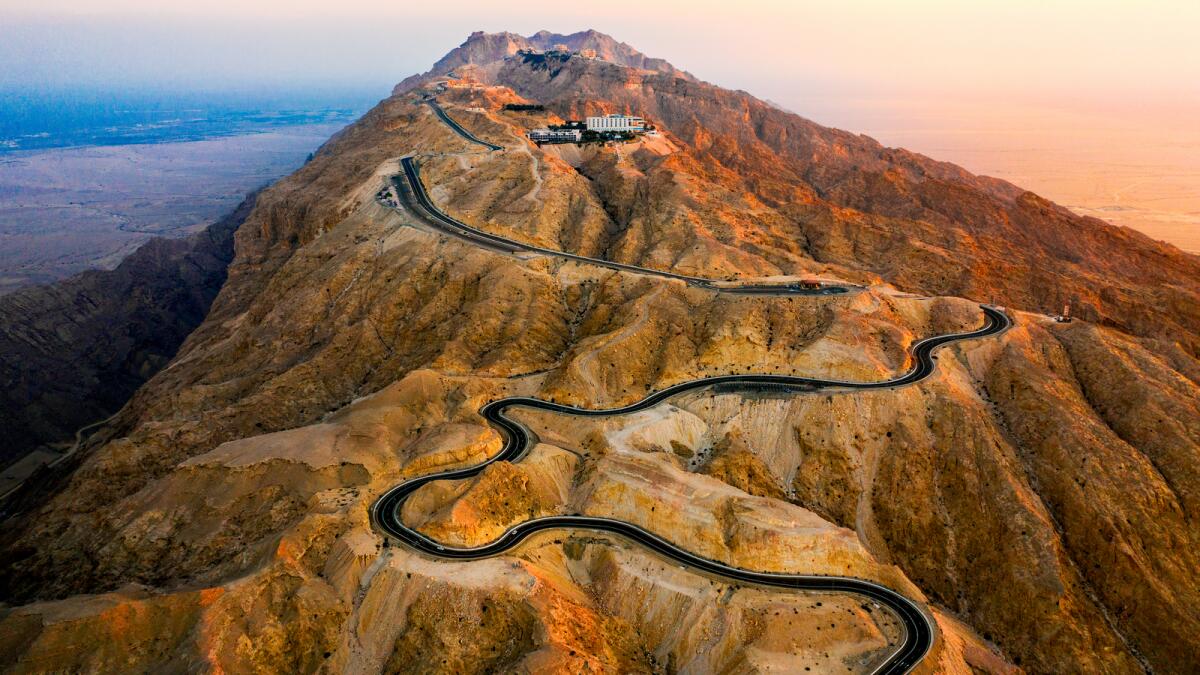A panoramic view of the winding roads of the Jebel Hafit mountains as the sun rises. Photo: Supplied