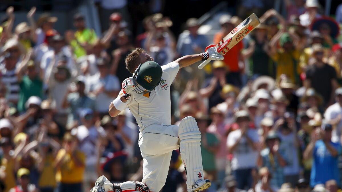 David Warner celebrates his century during the opening day of the second Test against New Zealand in Perth. 