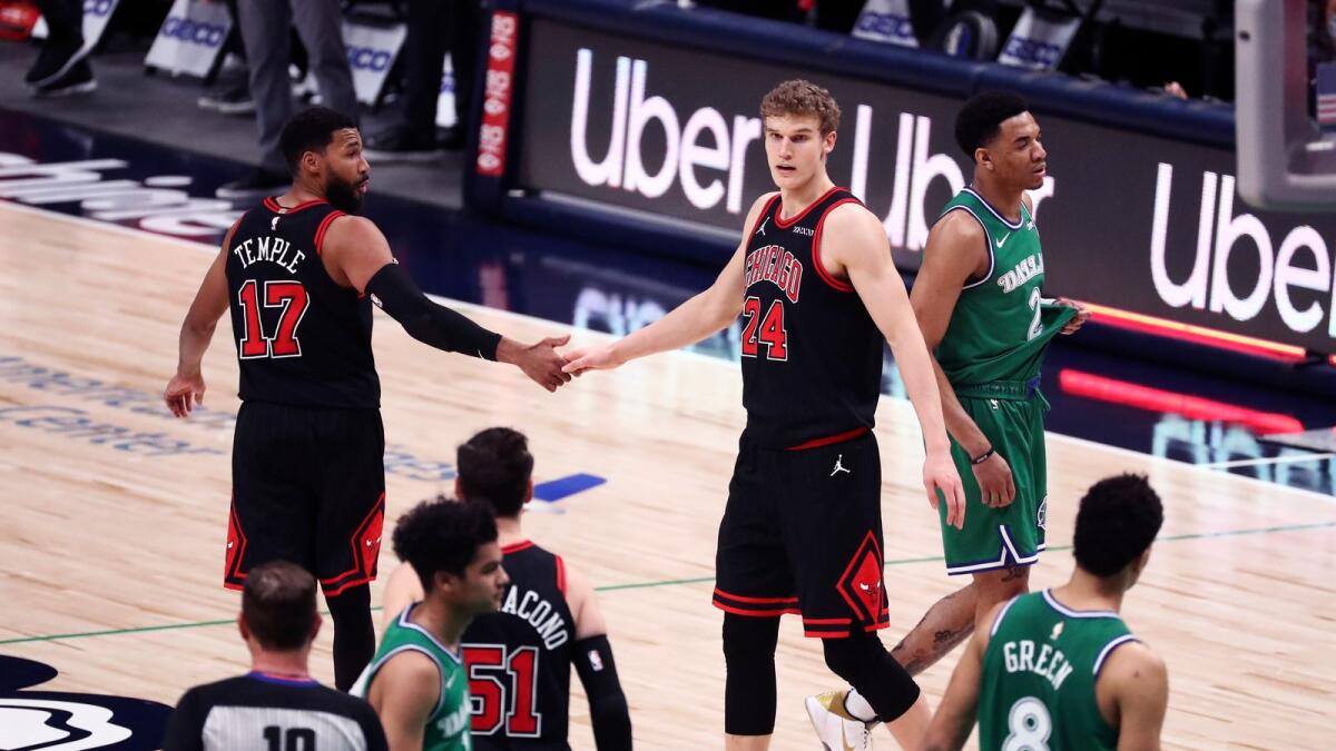 Chicago Bulls forward Lauri Markkanen (24) and guard Garrett Temple (17) celebrate after the game against the Dallas Mavericks. — Reuters