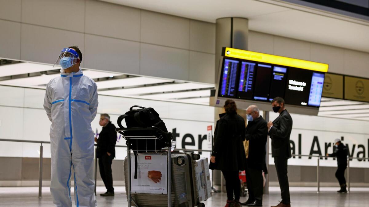 A man wears personal protective equipment at the arrivals area at Heathrow Airport. Reuters