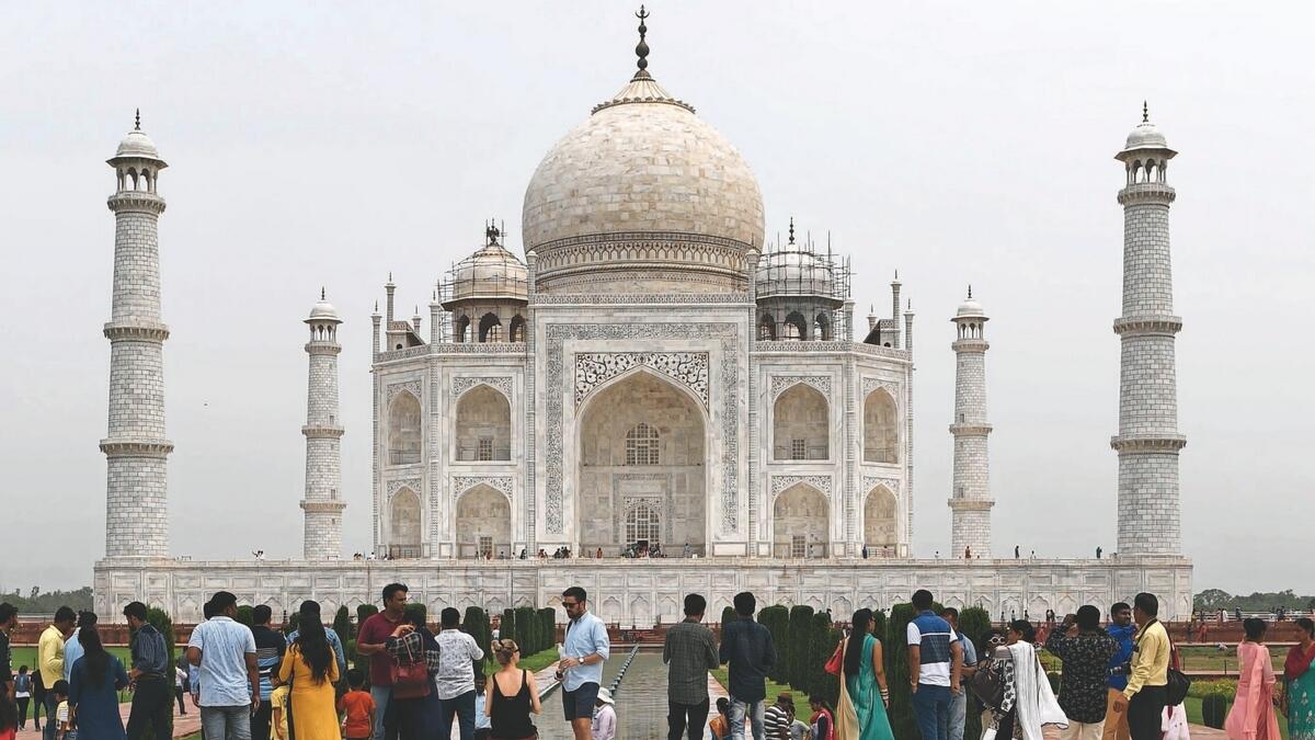 Tourists visit the Taj Mahal in Agra.