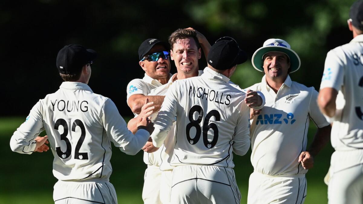 New Zealand's Matt Henry and teammates celebrate the wicket of Dean Elgar during the second day of the first Test. (AP)