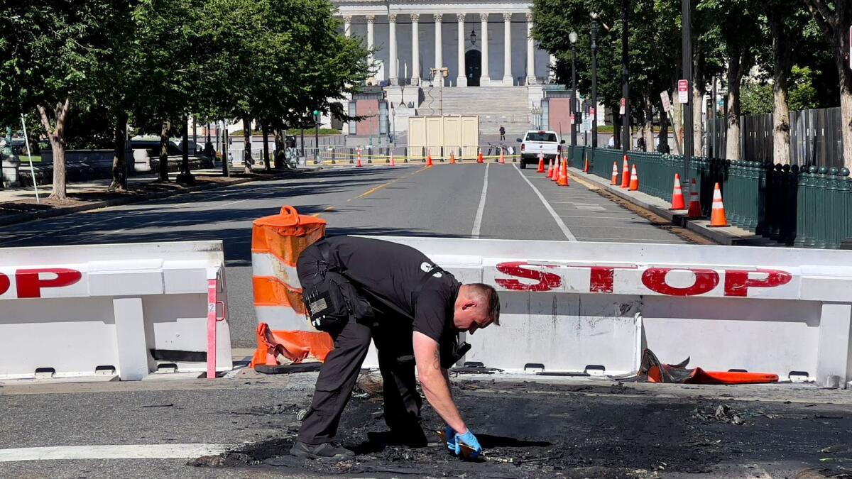 A US Capitol Police Officer works near a police barricade on Capitol Hill in Washington, DC, on Sunday. — AFP