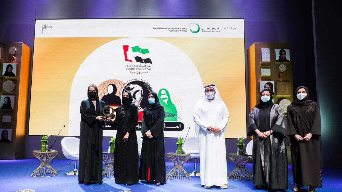 Khawla Al Mehairi, EVP of Strategy and Government Communications at DEWA giving a trophy to Dr. Manal Taryam, CEO of Primary Healthcare Services Sector, Dubai Health Authority. Also seen in the photo is Dr. Yousef Al Akraf, EVP of Business Support &amp; Human Resources and  Fatima Al Jokar, Chairperson of DEWA Women’s Committee. Supplied photo
