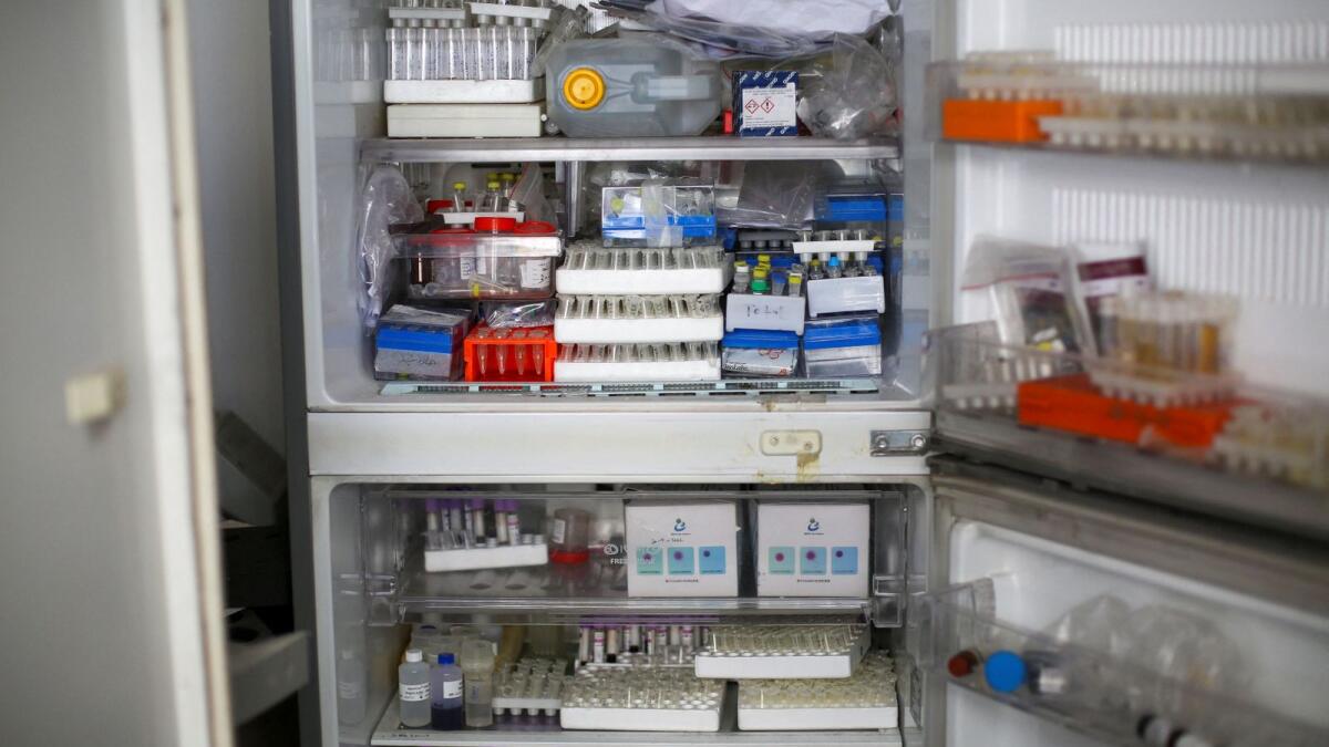 Tubes of specimens are seen in a broken fridge inside Al Basma IVF Centre. — Reuters