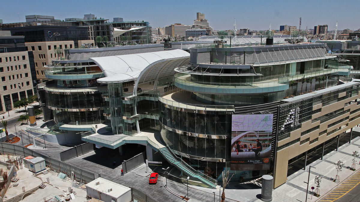In this July 5, 2016 photo, a car pulls into the new Abdali Mall, Jordan's first energy-efficient shopping complex in Amman, Jordan. High-end boutiques, cinemas and gourmet coffee shops are tucked into an intricate ecosystem of natural heating and cooling, water recycling and hundreds of solar panels soaking up the sun's rays. Advocates for green building say sustainable building development is important in Jordan, where energy and water resources are quickly diminishing. (Layla Quran/AP Photo)