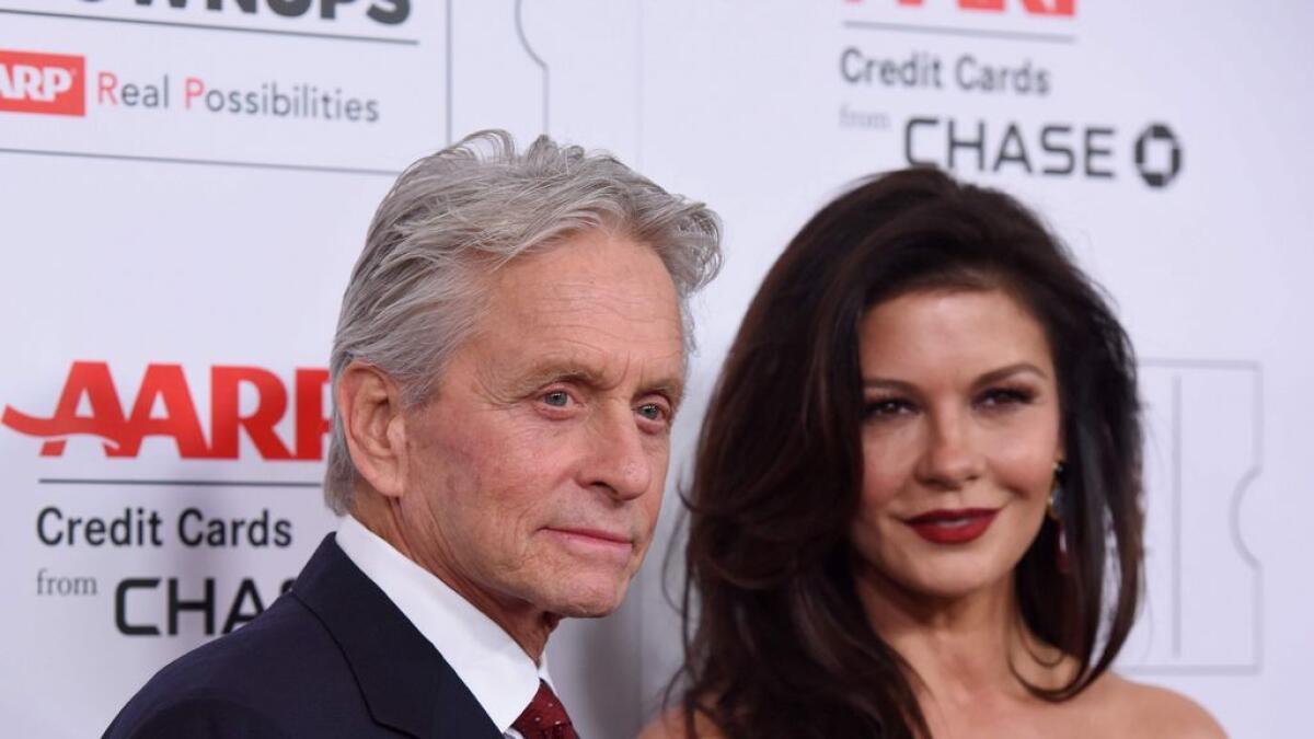 Michael Douglas (L) and wife Catherine Zeta-Jones arrive for the 15th Annual Movies for Grownups Awards in Beverly Hills, California.