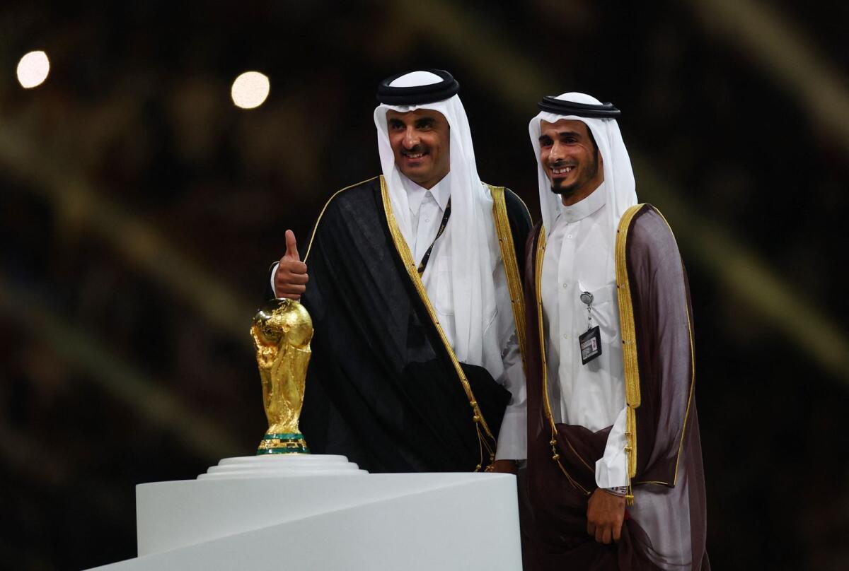 Emir of Qatar Sheikh Tamim bin Hamad Al Thani poses with the World Cup trophy during the presentation ceremony. Photo: Reuters