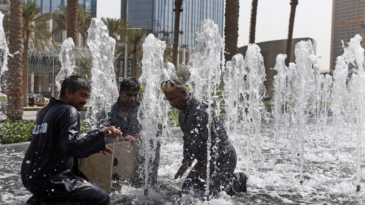 Maintenance workers work on the fountain at the Armani Hotel in Dubai on. -Photo by Dhes Handumon/ Khaleej Times