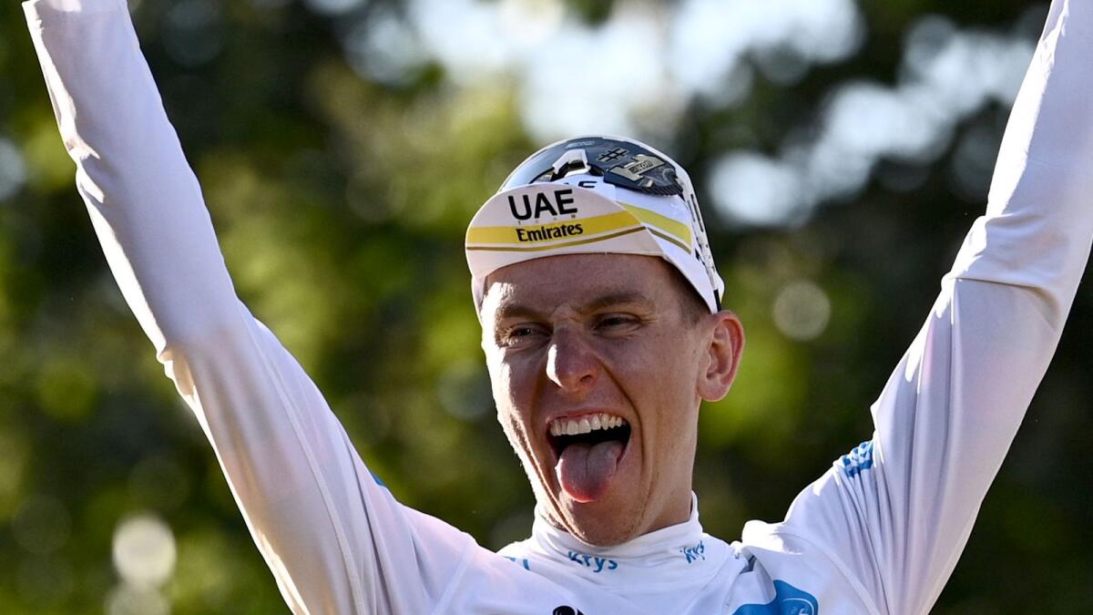 UAE Team Emirates' Tadej Pogacar of Slovenia celebrates after winning the Tour de France. (AFP)