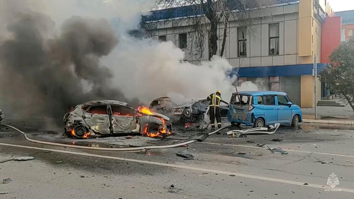In this photo taken from video released by Russia Emergency Situations Ministry telegram channel on Saturday, firefighters extinguish burning cars after shelling in Belgorod. — AP