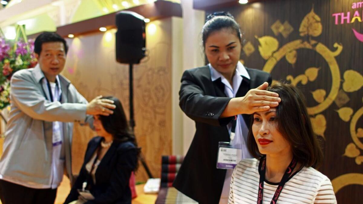 Thai massage being performed at the Thailand pavilion during Arabian Travel Market 2016 at the Dubai World Trade Centre on Tuesday.