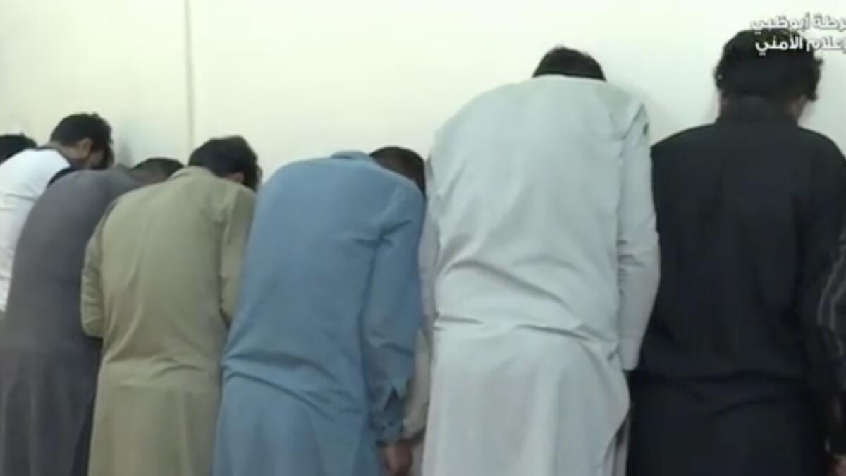 Gang members lined up by police forces during the raid. Thirteen phone scam gangs involving 142 people were arrested in Abu Dhabi since last year for duping residents of their cash after illegally obtaining their bank details, police has announced. The fraudsters, mostly Asians, were caught in various operations from 2019 until February 2020.