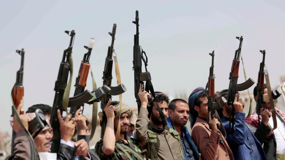 Tribesmen loyal to Houthi rebels raise their weapons during a protest in Sanaa. — AP file