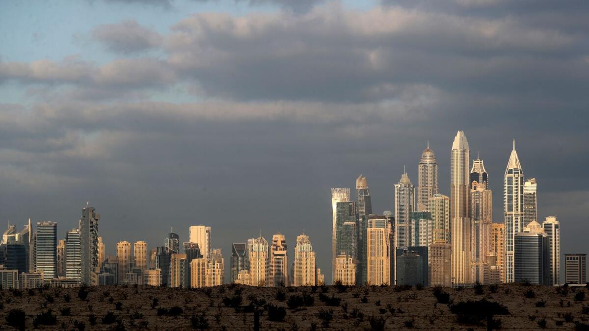 The sunrise reflects on city skyline at the Marina and Jumeirah Lake Towers districts in Dubai. The World Bank report describes GCC economies as rebounding robustly from the Covid-19 pandemic in the course of 2021 and at the beginning of 2022. — AP file photo