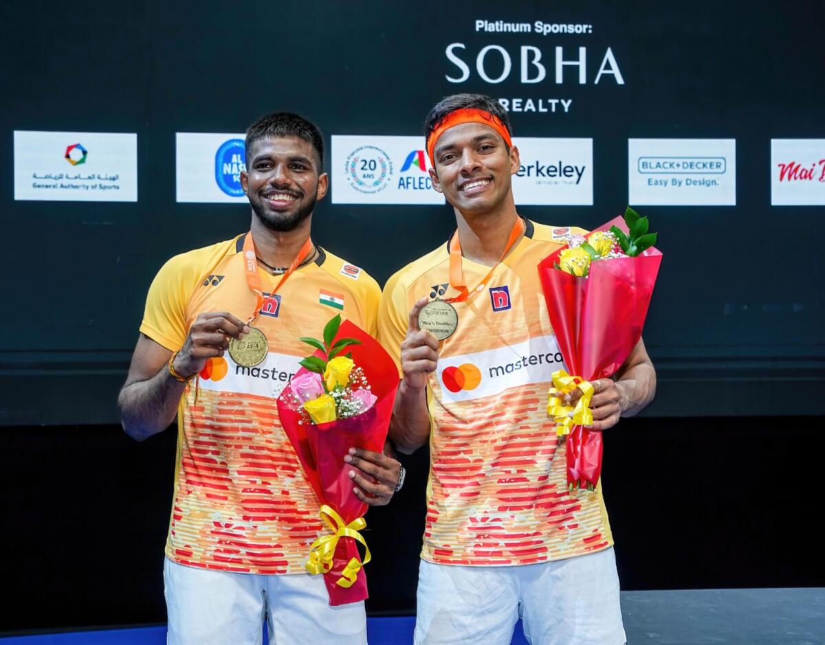 India's Satwiksairaj Rankireddy and Chirag Shetty pose with their gold medals. — UAE Badminton Federation
