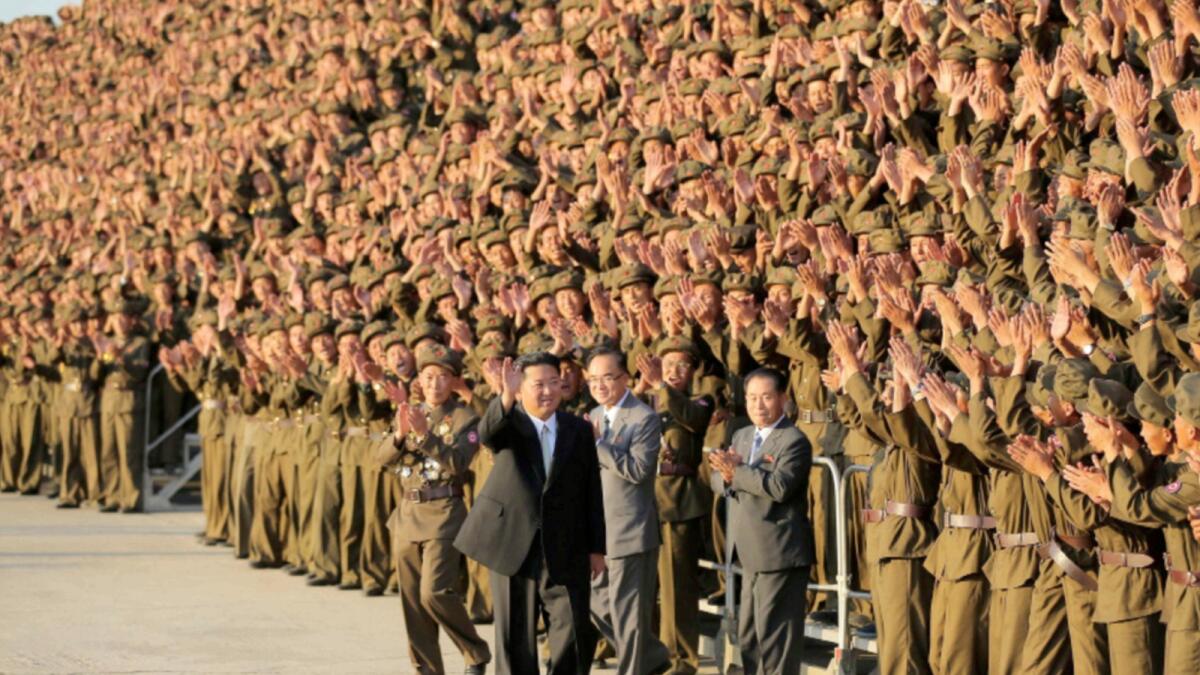 North Korean leader Kim Jong Un greets military members. — Reuters