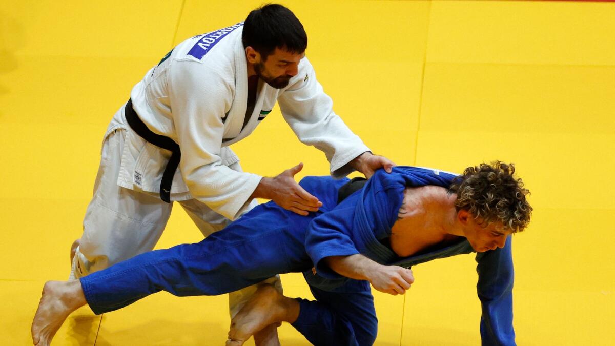 UAE's judoka Victor Scvortov (white) competes with Italy's Giovanni Esposito in the men's under 73kg category at the Tel Aviv Grand Slam on February 19, 2021. (AFP file)